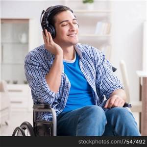 The disabled man listening to music in wheelchair. Disabled man listening to music in wheelchair