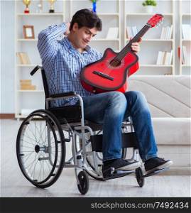 The disabled man playing guitar at home. Disabled man playing guitar at home