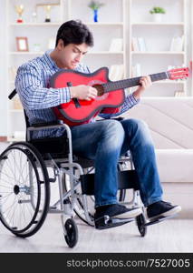 The disabled man playing guitar at home. Disabled man playing guitar at home