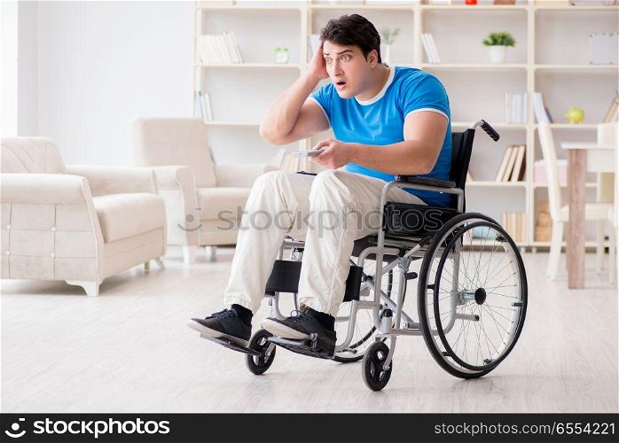 The disabled man watching sports on tv. Disabled man watching sports on tv