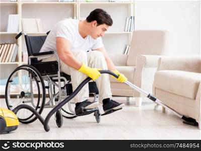 The disabled man with vacuum cleaner at home. Disabled man with vacuum cleaner at home