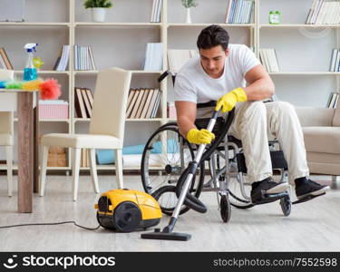 The disabled man with vacuum cleaner at home. Disabled man with vacuum cleaner at home