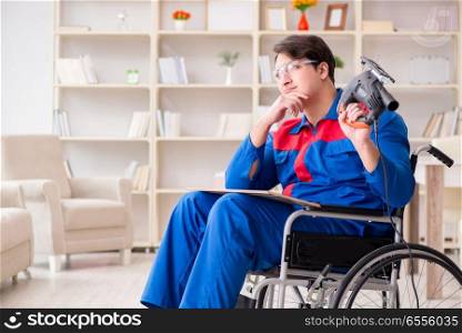 The disabled man working with handsaw at home. Disabled man working with handsaw at home