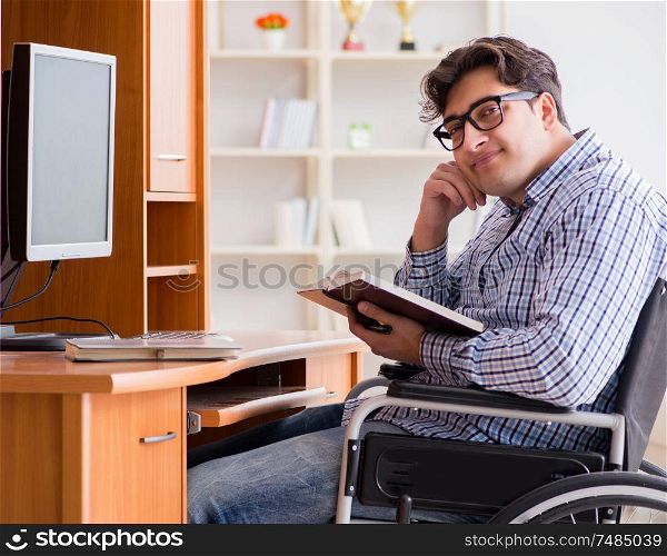 The disabled student studying at home on wheelchair. Disabled student studying at home on wheelchair