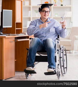 The disabled student studying at home on wheelchair. Disabled student studying at home on wheelchair