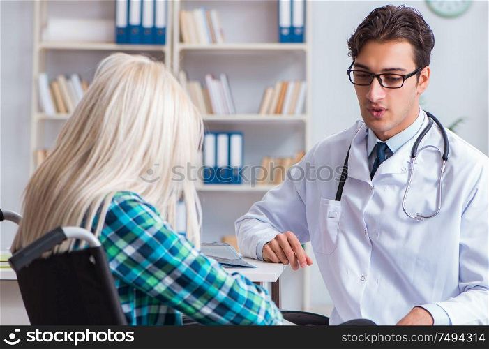 The disabled woman in wheel chair visiting man doctor. Disabled woman in wheel chair visiting man doctor
