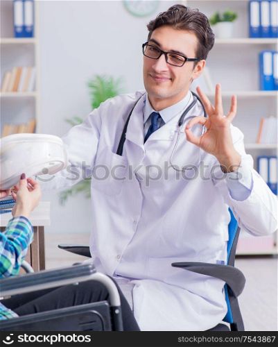 The disabled woman in wheel chair visiting man doctor. Disabled woman in wheel chair visiting man doctor