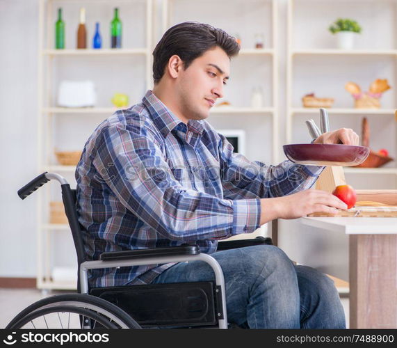 The disabled young husband frying at kitchen. Disabled young husband frying at kitchen