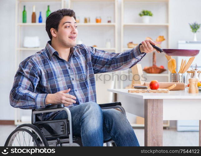 The disabled young husband frying at kitchen. Disabled young husband frying at kitchen