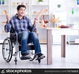 The disabled young man husband workin in kitchen. Disabled young man husband workin in kitchen