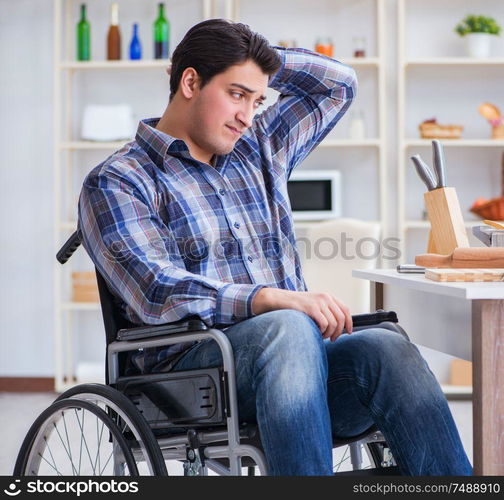 The disabled young man husband working in kitchen. Disabled young man husband working in kitchen