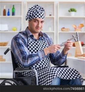 The disabled young man husband working in kitchen. Disabled young man husband working in kitchen