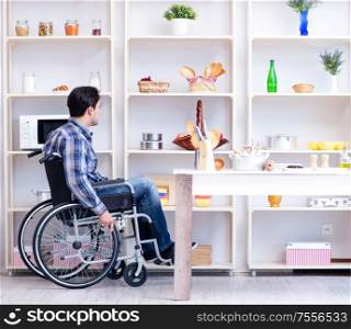 The disabled young man husband working in kitchen. Disabled young man husband working in kitchen