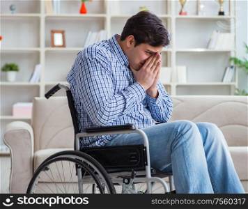 The disabled young man suffering at home. Disabled young man suffering at home