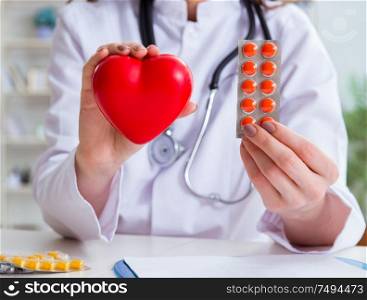 The doctor cardiologist with red heart in the hospital. Doctor cardiologist with red heart in the hospital