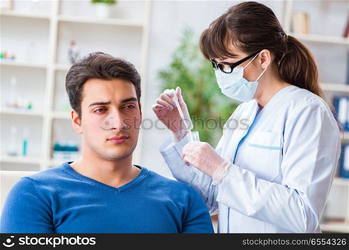 The doctor checking patients ear during medical examination. Doctor checking patients ear during medical examination