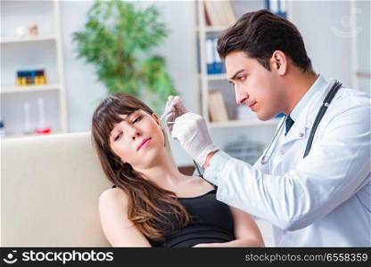 The doctor checking patients ear during medical examination. Doctor checking patients ear during medical examination