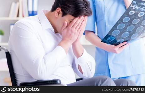 The doctor discussing x-ray image with patient. Doctor discussing x-ray image with patient