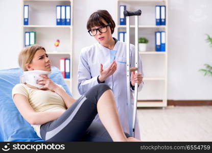 The doctor examining injured woman in hospital. Doctor examining injured woman in hospital