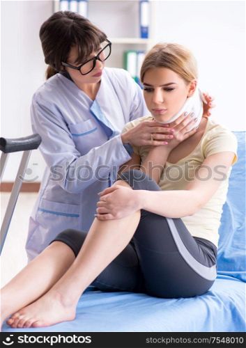 The doctor examining injured woman in hospital. Doctor examining injured woman in hospital