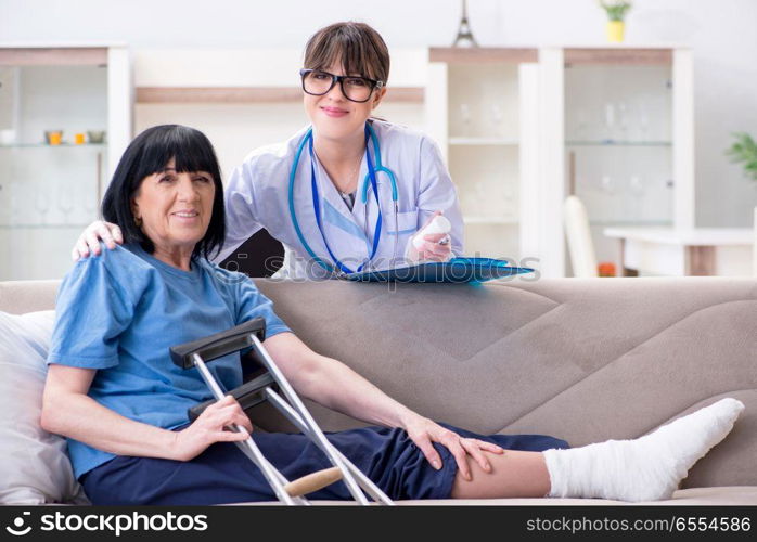 The doctor examining old mature woman after incident. Doctor examining old mature woman after incident