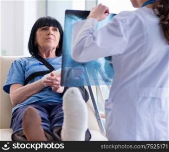 The doctor examining old mature woman after incident. Doctor examining old mature woman after incident
