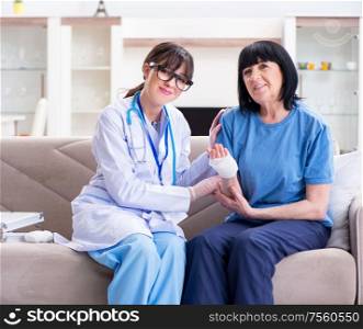 The doctor examining old mature woman after incident. Doctor examining old mature woman after incident