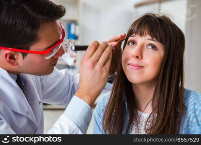 The doctor examining patients eye in hospital. Doctor examining patients eye in hospital