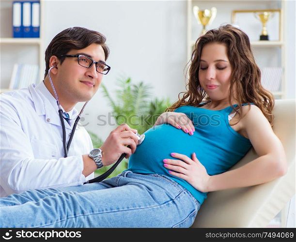 The doctor examining pregnant female patient in hospital. Doctor examining pregnant female patient in hospital