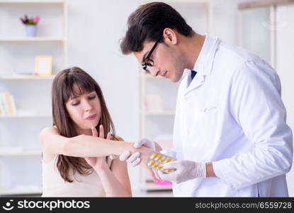 The doctor examining the skin of female patient. Doctor examining the skin of female patient