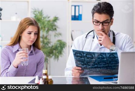 The doctor examining x-ray images of patient. Doctor examining x-ray images of patient
