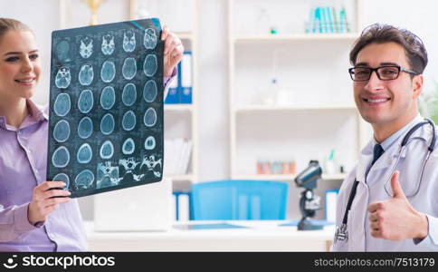 The doctor examining x-ray images of patient. Doctor examining x-ray images of patient