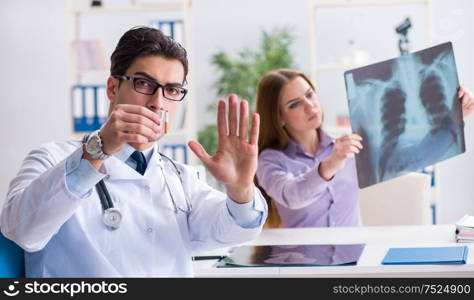 The doctor examining x-ray images of patient. Doctor examining x-ray images of patient