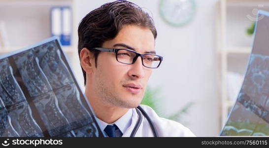 The doctor examining x-ray images of patient. Doctor examining x-ray images of patient