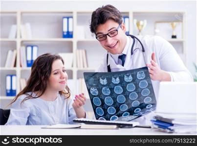 The doctor explaining to patient results of x-ray imaging. Doctor explaining to patient results of x-ray imaging