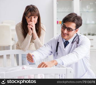 The doctor explaining to young mother. Doctor explaining to young mother