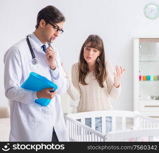 The doctor explaining to young mother. Doctor explaining to young mother