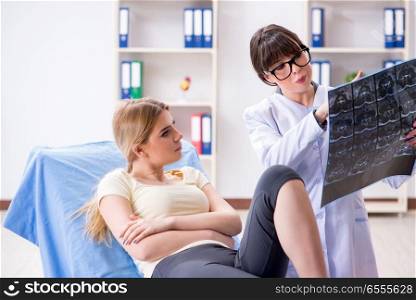The doctor explaining x-ray scan during consultation. Doctor explaining x-ray scan during consultation