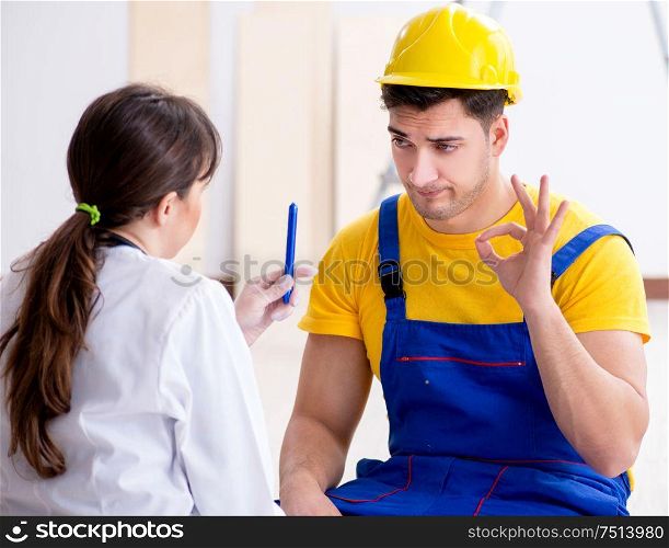 The doctor helping injured worker at construction site. Doctor helping injured worker at construction site