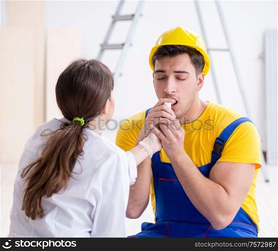 The doctor helping injured worker at construction site. Doctor helping injured worker at construction site
