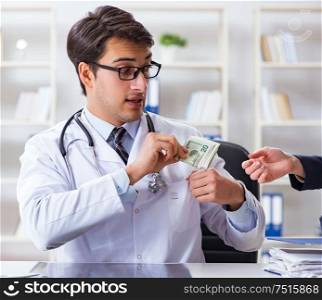 The doctor in corruption concept with being offered bribe. Doctor in corruption concept with being offered bribe