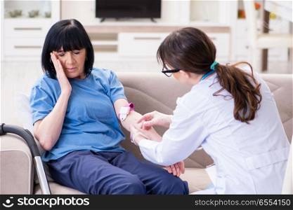 The doctor making injection to senior old woman. Doctor making injection to senior old woman