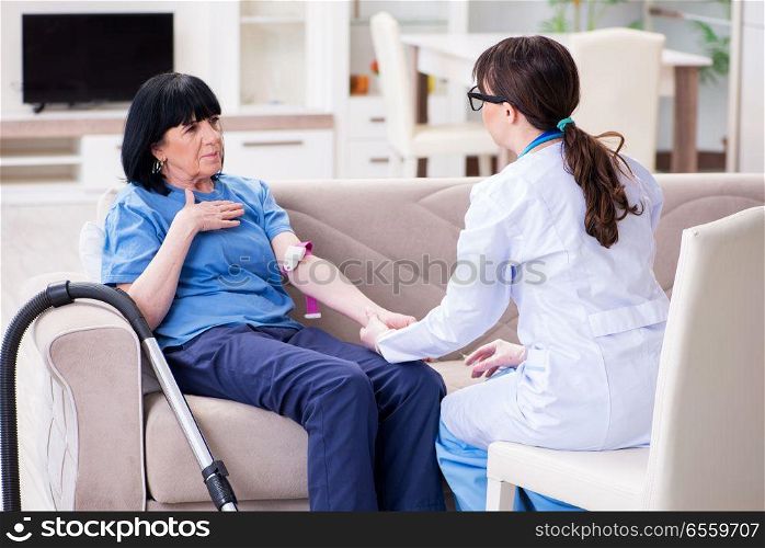 The doctor making injection to senior old woman. Doctor making injection to senior old woman