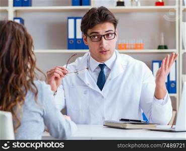 The doctor optician prescribing glasses to a patient. Doctor optician prescribing glasses to a patient