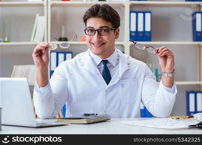 The doctor optician prescribing holding optical glasses . Doctor optician prescribing holding optical glasses