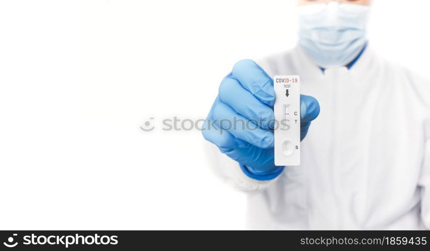 The doctor showing Covid-19 negative test result of the antigen rapid test kit on white background and copy space,Coronavirus infectious protect concept