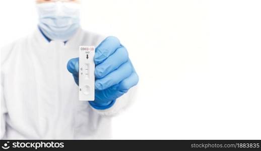 The doctor showing Covid-19 positive test result of the antigen rapid test kit on white background and copy space,Coronavirus infectious protect concept