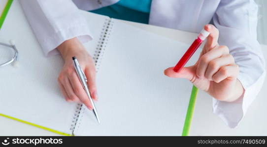 The doctor studying tube of blood in medical concept. Doctor studying tube of blood in medical concept