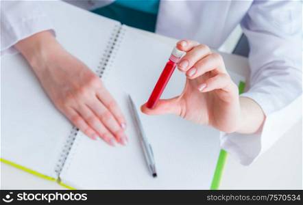 The doctor studying tube of blood in medical concept. Doctor studying tube of blood in medical concept