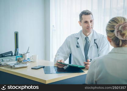 The doctor talked to the patient and tablet in office at hospital.